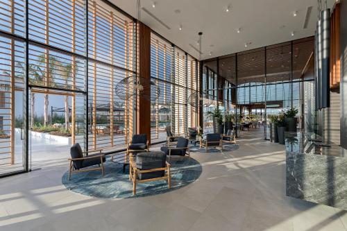 a lobby with chairs and windows in a building at D' Andrea Lagoon All Suites - Adults Only in Marmari
