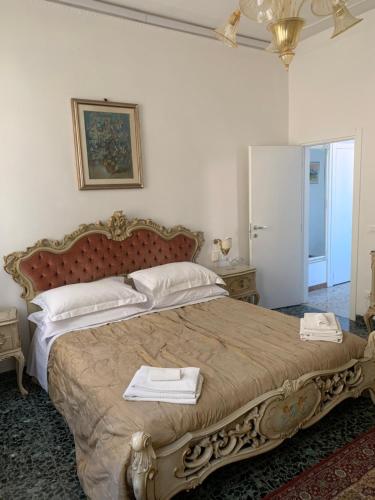a bedroom with a large bed with two towels on it at Venice San Leonardo in Venice