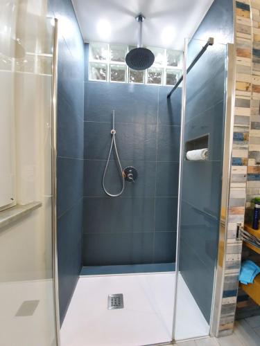 a shower with a glass door in a bathroom at Arco del Sole in Palermo