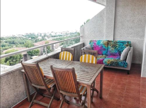 a balcony with a table and chairs and a couch at BEACH HOUSE. CASA CON PISCINA PRIVADA in Calafell