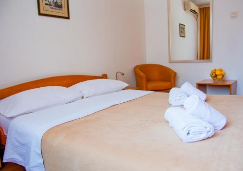 a bedroom with two beds with white towels on them at Hotel Srbija in Belgrade