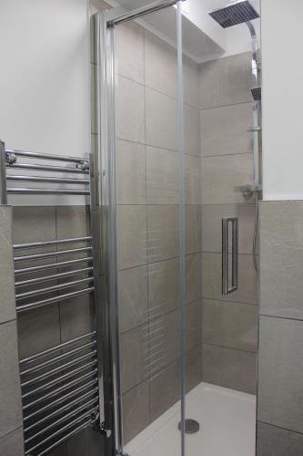 a shower with a glass door in a bathroom at Fabulous One Bedroom Apartment in Ripon City Centre in Ripon