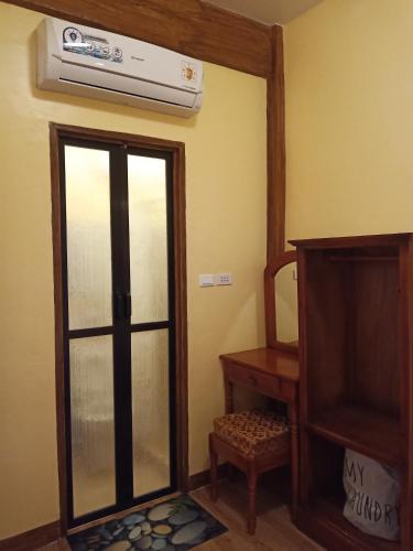 a living room with a glass door and a heater at TAGBALAYON Lodging House in Siquijor