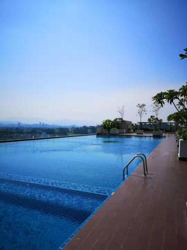 a large swimming pool with blue water at Harmony Studio @ Evo SOHO Bangi in Kampong Sungai Ramal Dalam