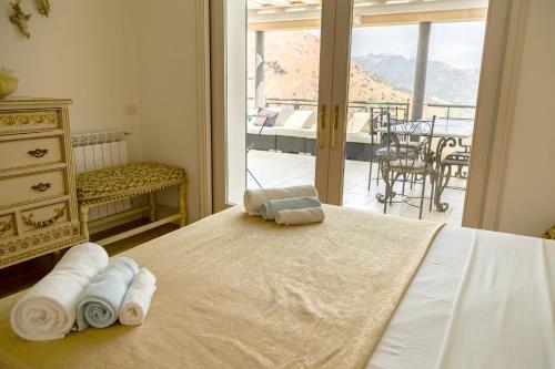 a bedroom with a bed with towels on it at Ninfa Apartment - Taormina Holidays in Taormina