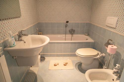 a bathroom with a sink and a toilet and a tub at Ninfa Apartment - Taormina Holidays in Taormina