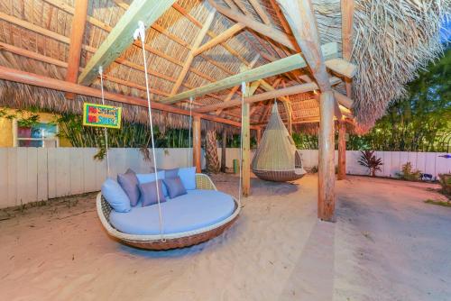 a swing in a pavilion with a hammock at Siesta Key Palms Resort in Sarasota