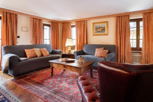 a living room with two couches and a coffee table at Maison Paquier - Central Family Escape in Valtournenche