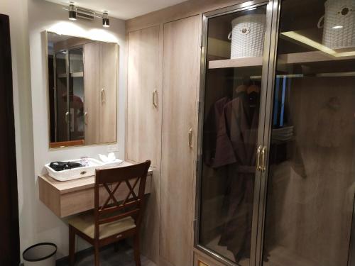 a bathroom with a glass shower and a sink at Hotel De Sripoom in Chiang Mai