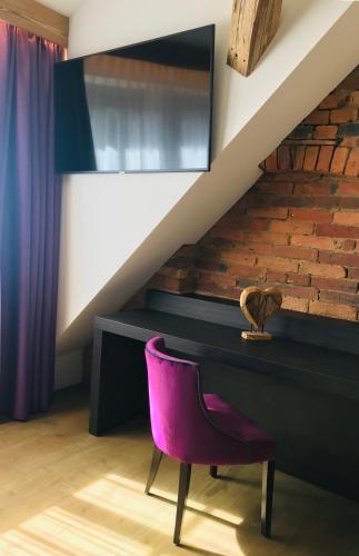 a purple chair in a room with a staircase at Gut am See in Görlitz