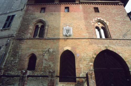 an old brick building with a tower with windows at Locanda Martelletti in Cocconato