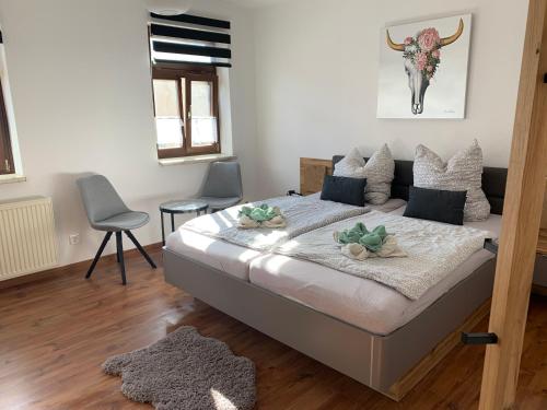 a bedroom with a bed and two chairs in it at Gästehaus Glücksmoment in Erfurt