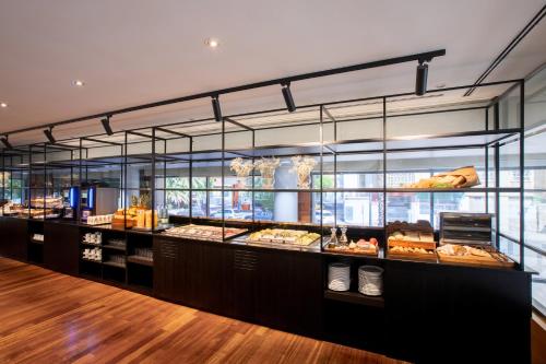 a bakery with a display case filled with different pastries at Eurostars Acteón in Valencia