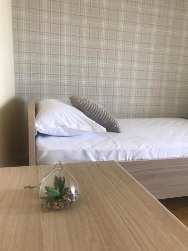 a room with a bed with a table with a pineapple on it at Anna Apartment Timișoara in Timişoara