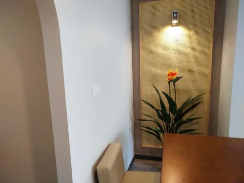 a flower sitting in a room with a table at Hotel De Sripoom in Chiang Mai