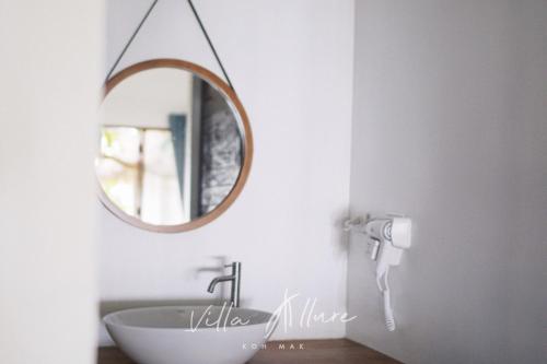 a bathroom with a sink and a mirror at Villa Allure Koh Mak in Ko Mak