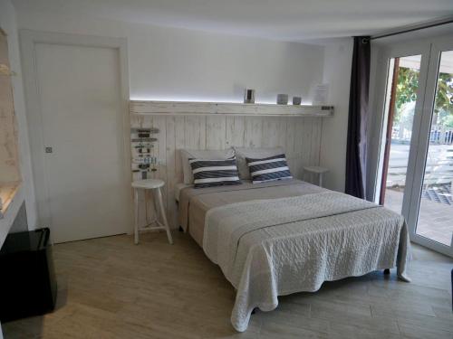 a bedroom with a bed with two pillows on it at L’Orto di Rina in Numana