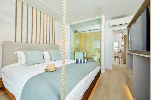 a bedroom with a swinging bed with a flat screen tv at Areias Senses in Albufeira