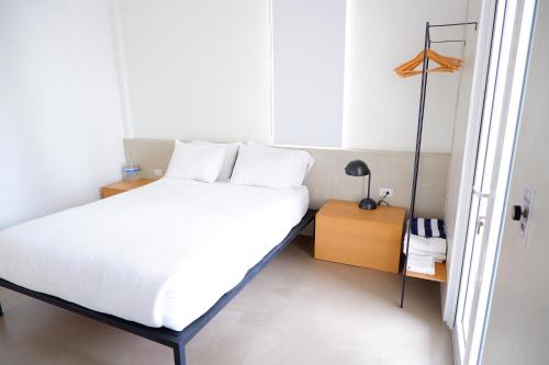 a small bedroom with a bed and a night stand at Stay at Mare in San Juan