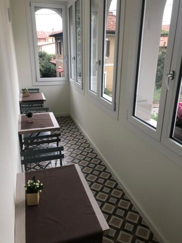 a corridor with tables and windows in a building at B&b estercarlo in Trezzo sullʼAdda