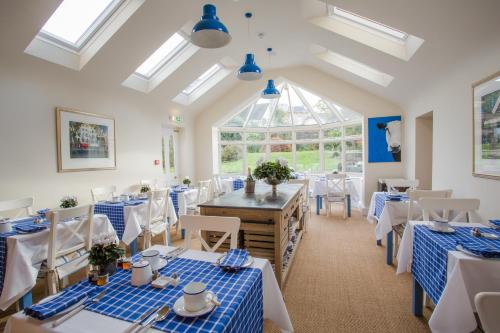 a dining room with blue and white tables and chairs at Grays Boutique B&B in Bath
