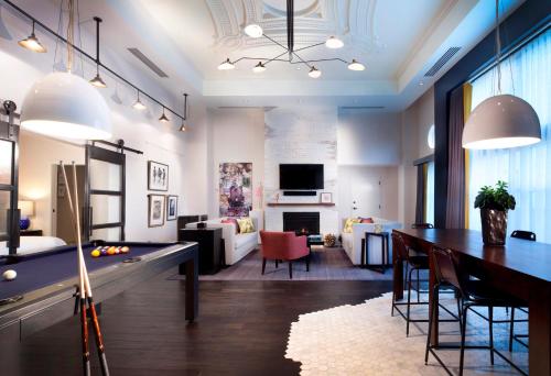 a room with a pool table and a living room at Hotel Commonwealth in Boston