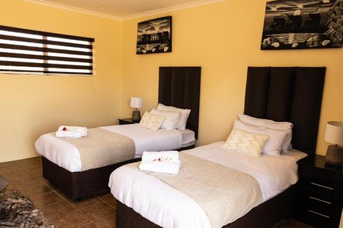A bed or beds in a room at Avela Lodge