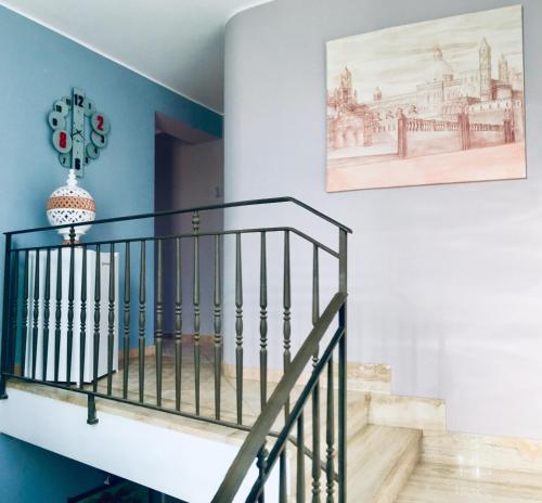 a staircase in a house with a picture on the wall at Casa vacanze Isolotto in Isola delle Femmine