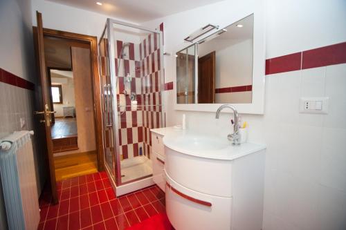 a white bathroom with a sink and a mirror at Casa Vacanza La Piazza in Orvinio