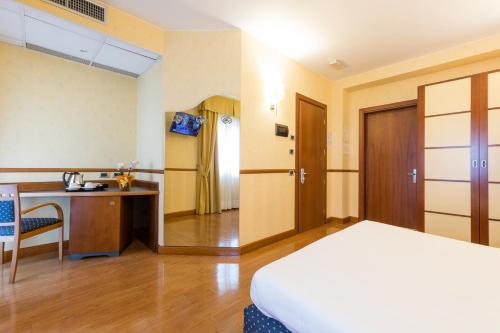 a hotel room with a bed and a desk at Best Western Hotel I Colli in Macerata