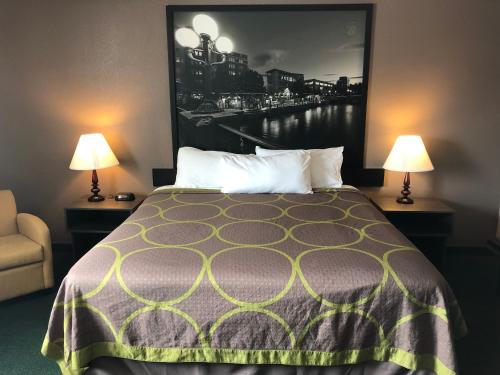a hotel room with a bed and two lamps at Super 8 by Wyndham Winnemucca NV in Winnemucca