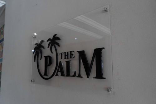 a sign for the palma sign on a wall at Visa Karena Hotels in Port Harcourt