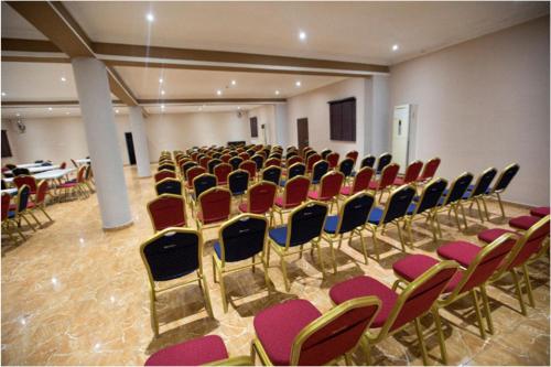 a large room with chairs and a table in it at Visa Karena Hotels in Port Harcourt