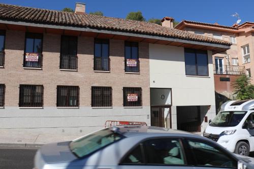 a car is parked in front of a building at Apartamento Roca Tarpeya 4 Parking incluido - Living Toledo in Toledo