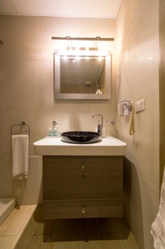 a bathroom with a sink and a mirror at Urban Faqra Hotel in Kfardebian