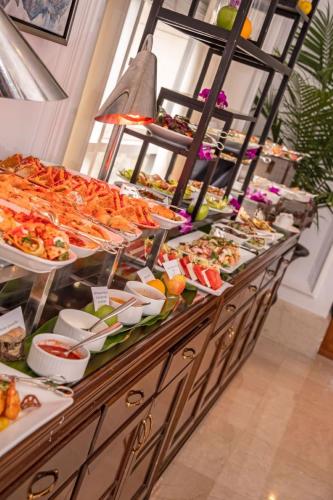 a buffet line with many different types of food at Garden City Hotel in Garden City