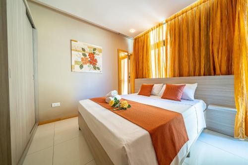 a hotel room with two beds and a window at Marsalforn Apartment Del Mar in Marsalforn