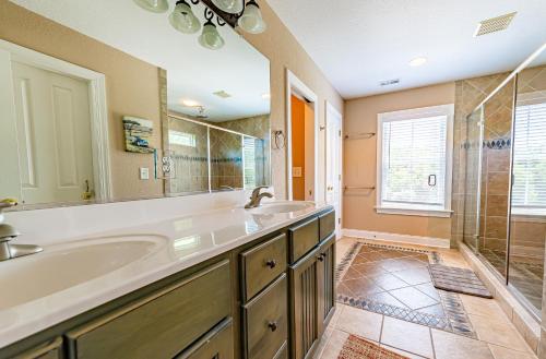 a bathroom with two sinks and a shower at Show Boat in Kitty Hawk