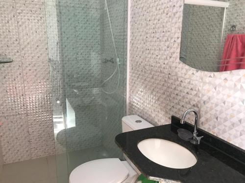 a bathroom with a toilet and a sink and a shower at Praia do Frances in Praia do Frances