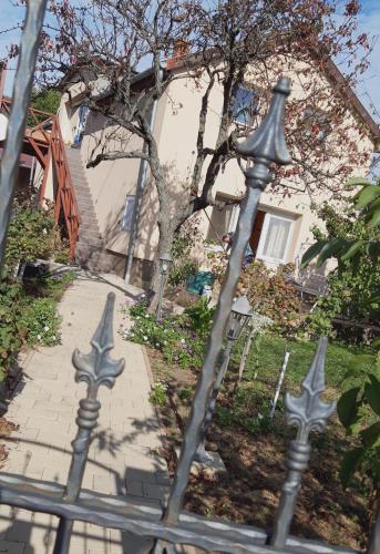 a metal fence with crosses on it in front of a house at AirPortOne in Vecsés