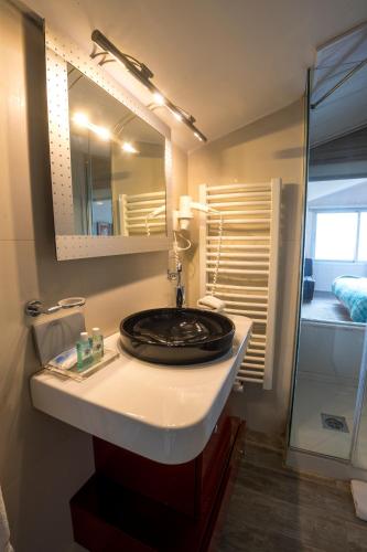 a bathroom with a sink and a mirror at Urban Faqra Hotel in Kfardebian