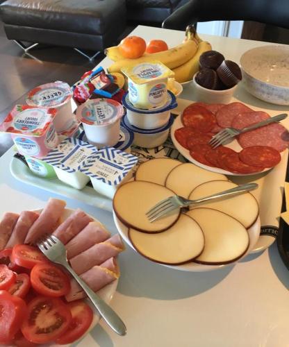 a table topped with plates of food and fruit at The Anchorage B and B in John O Groats