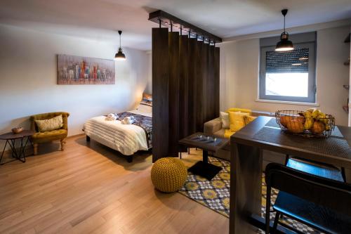 a living room with a bed and a dining room at Apartment Story,Nikole Cupica Beograd in Belgrade