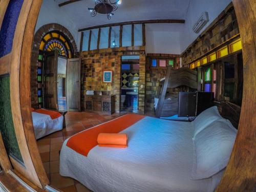 a bedroom with a large bed in a room at Hotel Hacienda Gualanday in Villavicencio