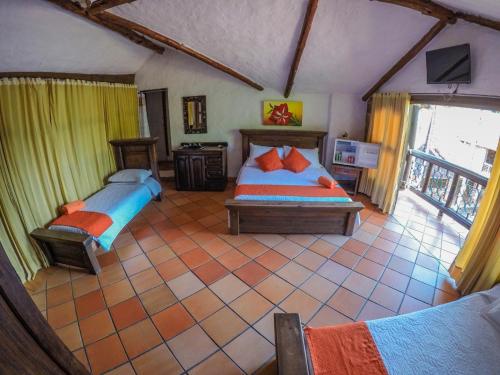 a bedroom with two beds in a room at Hotel Hacienda Gualanday in Villavicencio