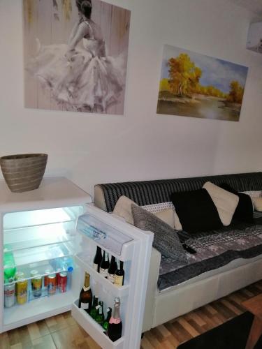 a room with a refrigerator with bottles in it at Apartman EDEN No 1 in Teslić