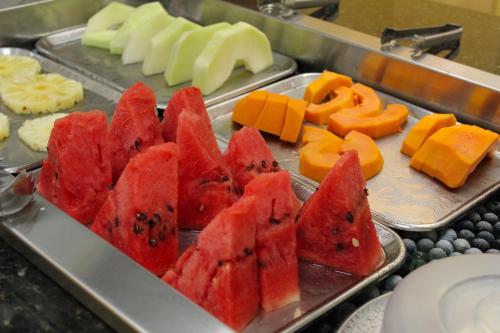 a tray of watermelon and other fruits on a table at Ônix Hotel in Assis