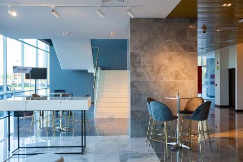 a lobby with chairs and a bar in a building at MDS Hotel Chillan in Chillán