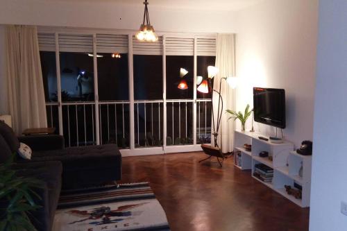 a living room with a large window and a television at Depto centrico, 90 m2, 2 habitaciones in Rosario