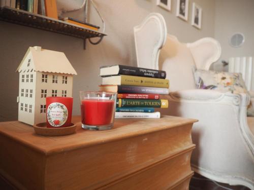a table with books and a glass of red drink at B&B Antique Maison in Soave